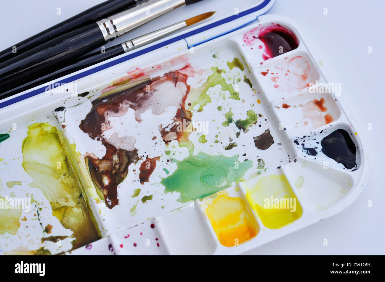 Watercolor paints in palette and brushes Stock Photo