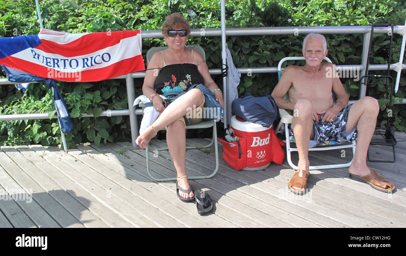 Puerto Rican couple displays the Puerto Rican flag as they enjoy the Fourth of July on the Coney Island boardwalk. Stock Photo