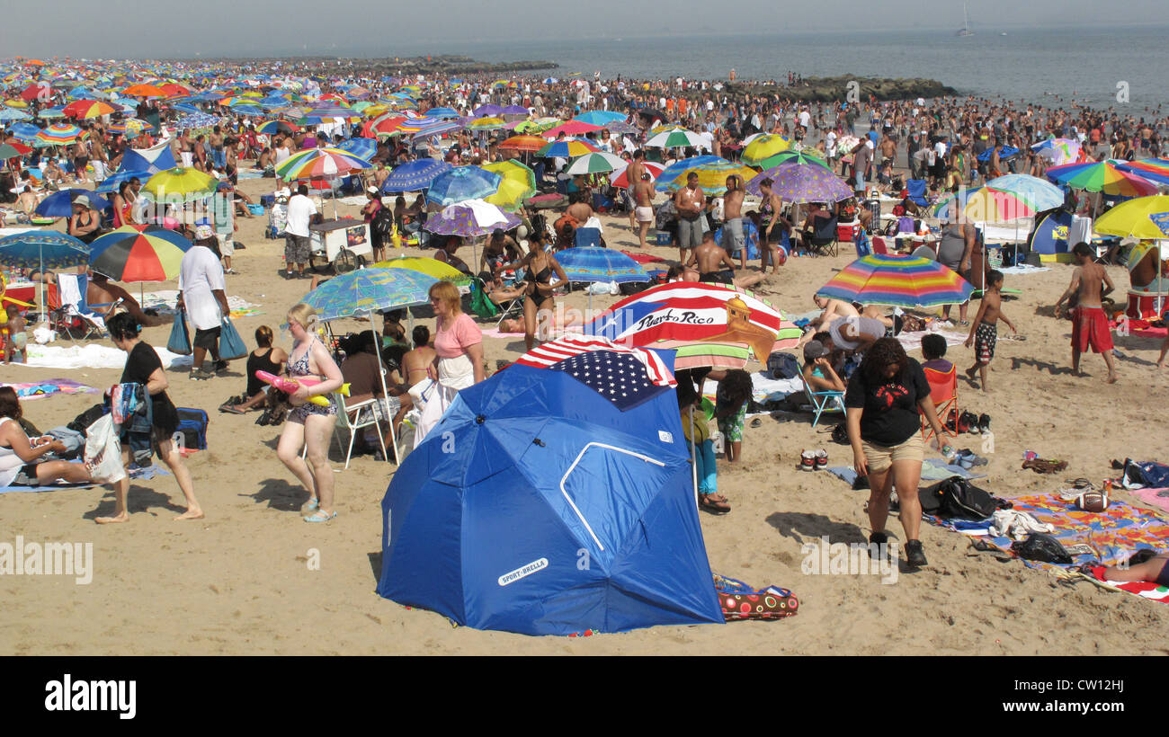Thousands of people enjoy the beach at Coney Island on the Fourth of ...