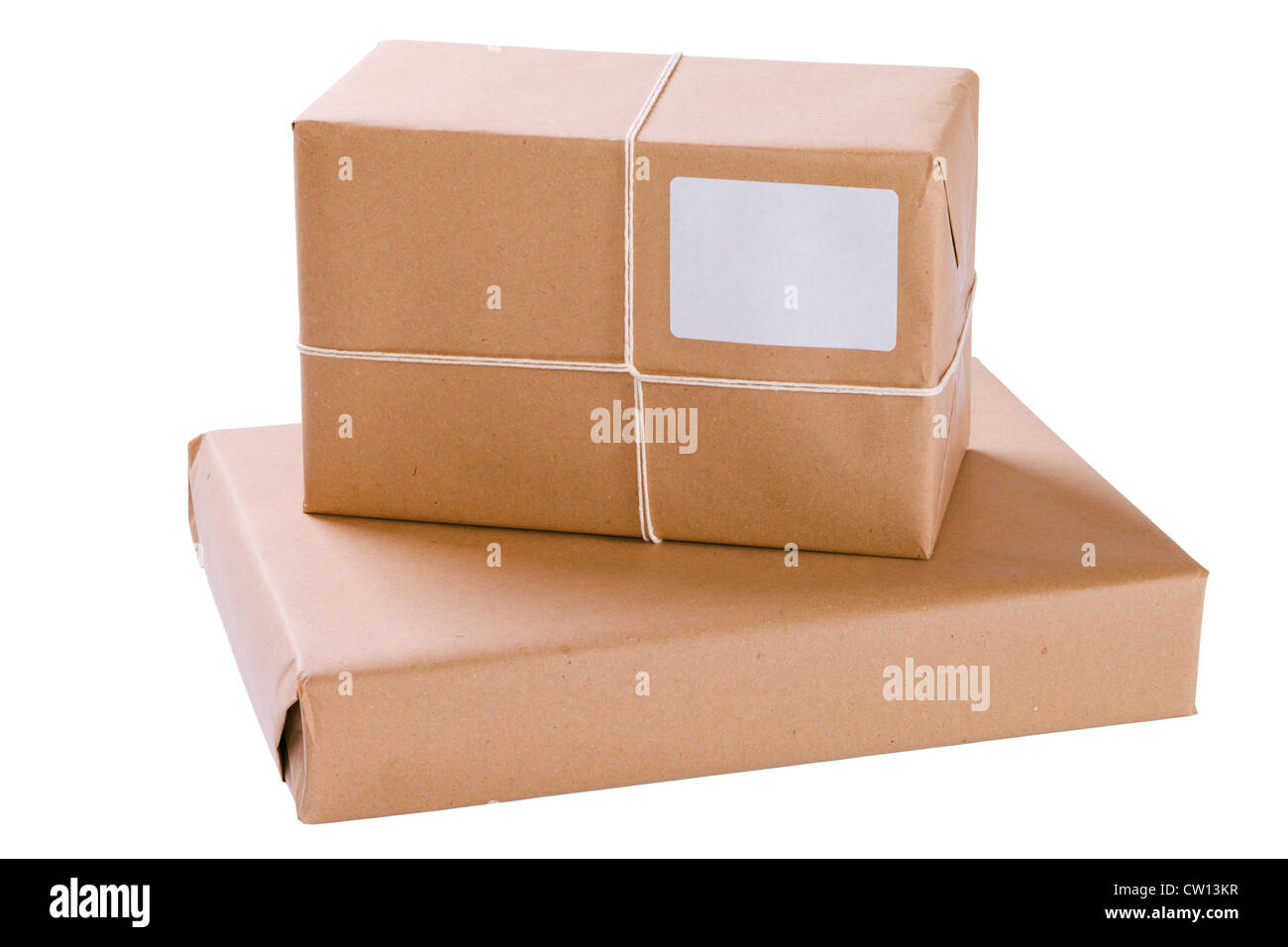 Two brown paper parcels in a stack, isolated on white with clipping path. Stock Photo