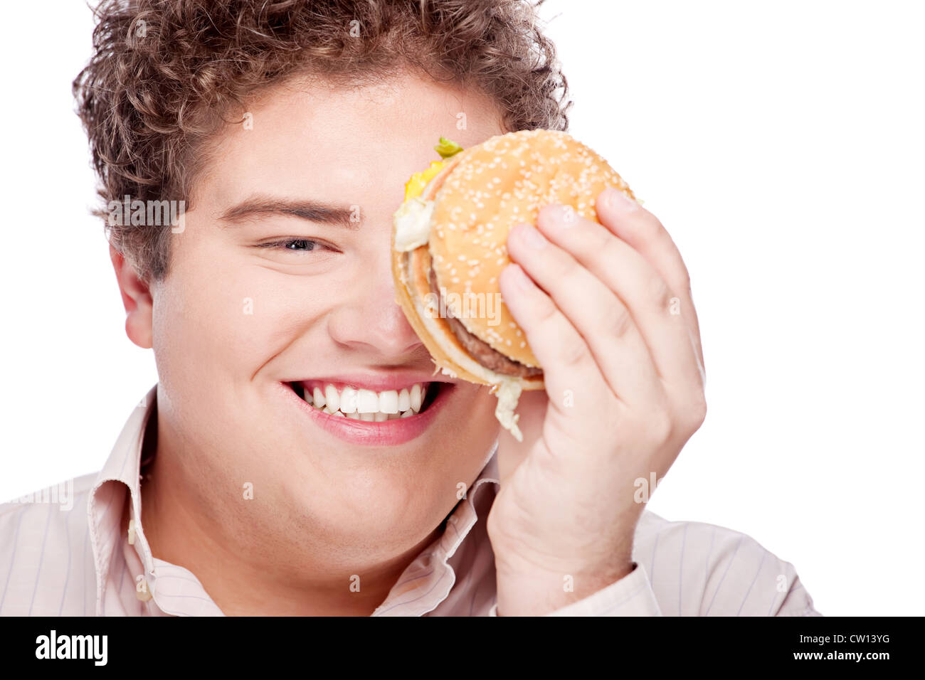 Young chubby man holding hamburger, isolated on white Stock Photo