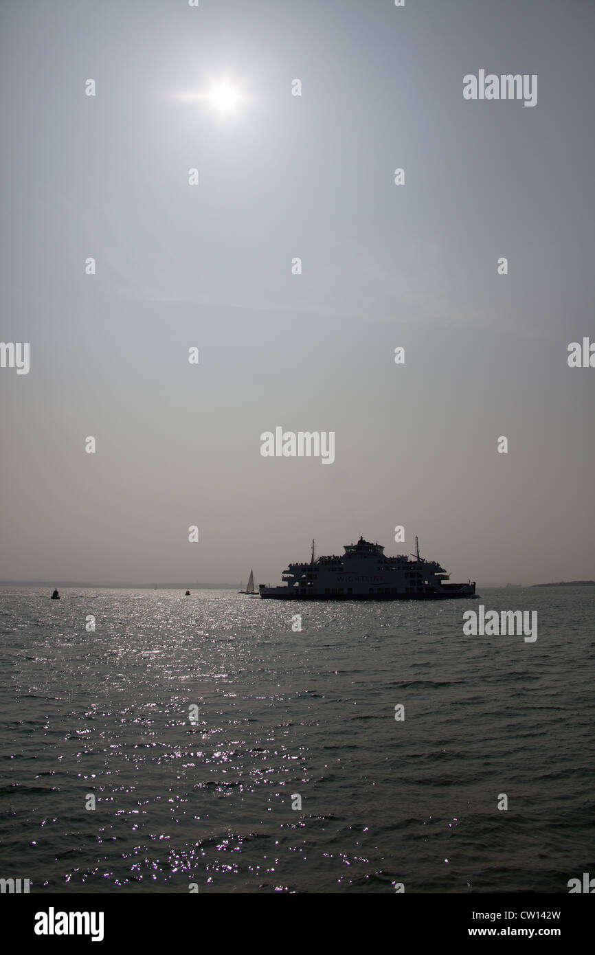 City of Portsmouth, England. Silhouetted view of the Wightlink Ferry MV St Clare on route from the Isle of Wight to Portsmouth. Stock Photo