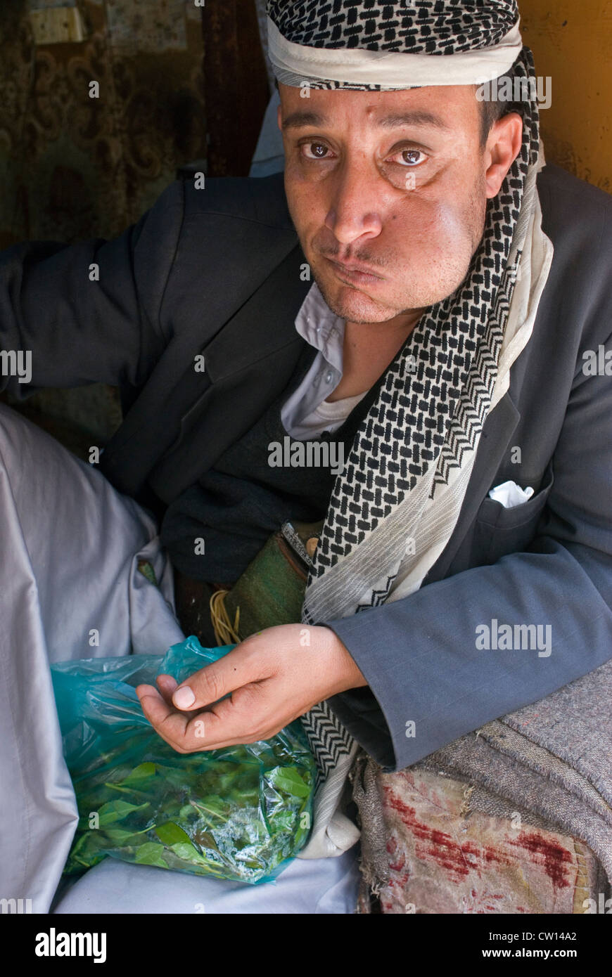 Man chewing Qat in the souk of Sana'a, a UNESCO World Heritage Site, Yemen, Western Asia, Arabian Peninsula. Stock Photo
