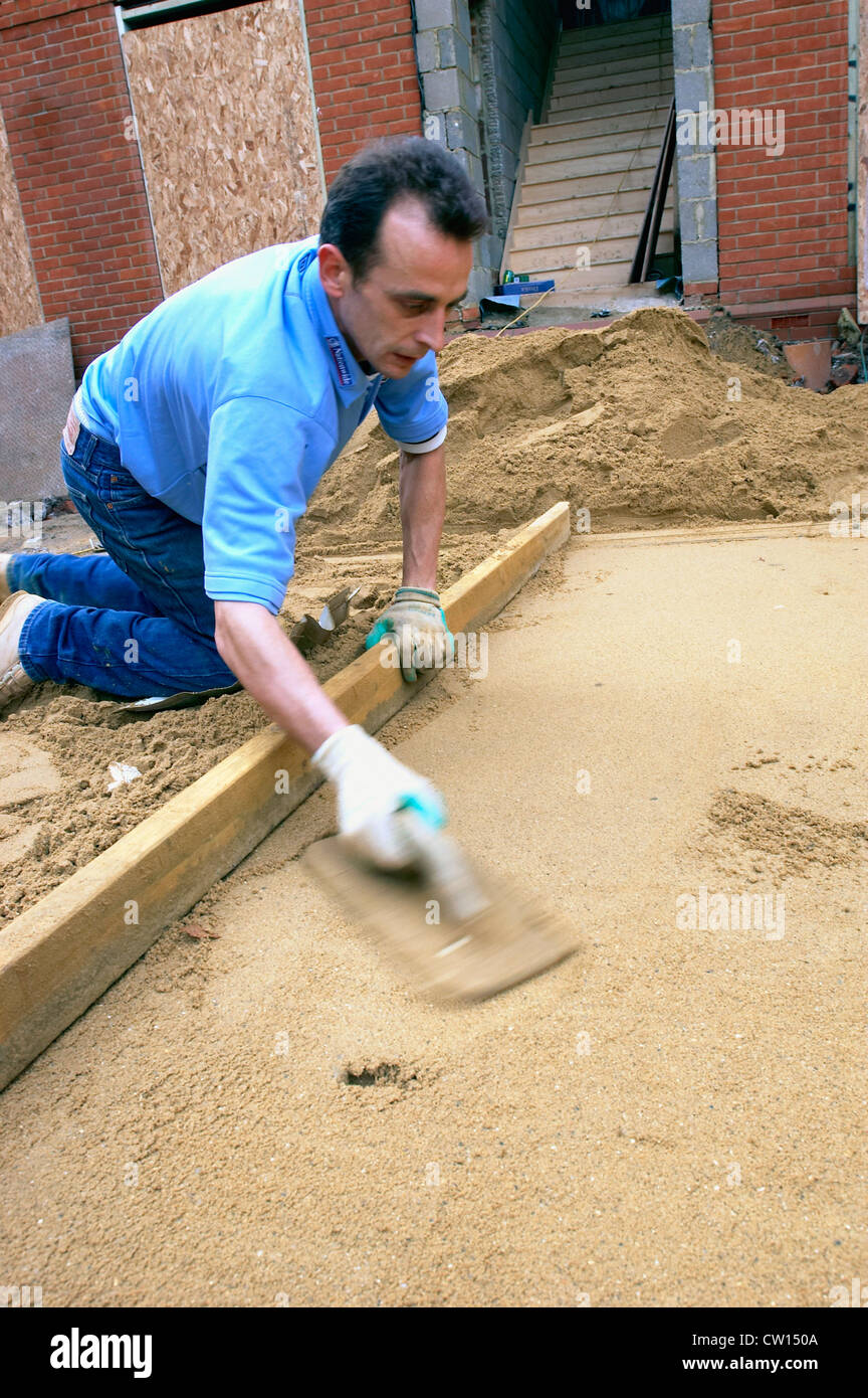 Laying sand for the foundation of a driveway. England, UK Stock Photo Alamy