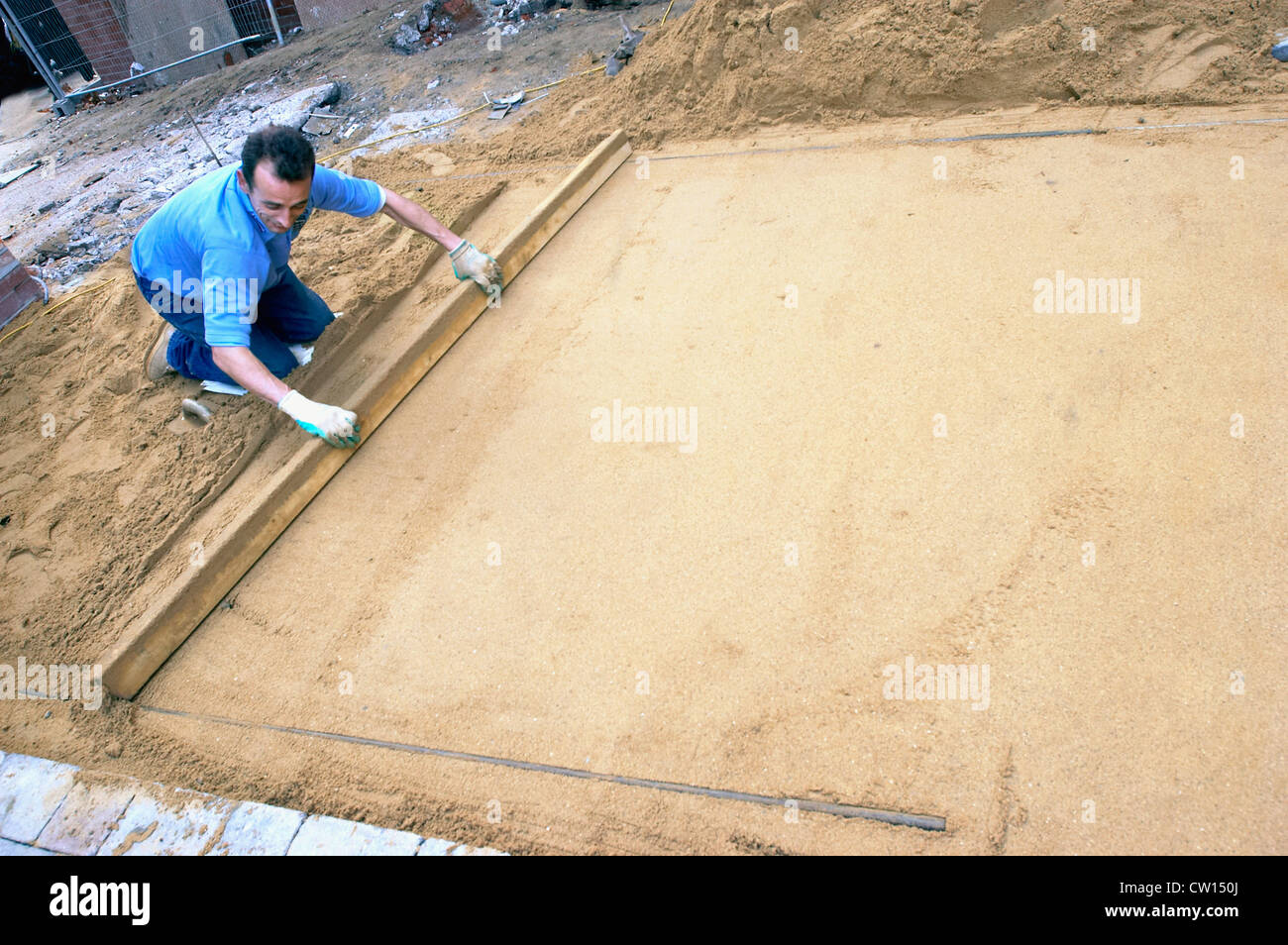 Laying sand for the foundation of a driveway. England, UK Stock Photo