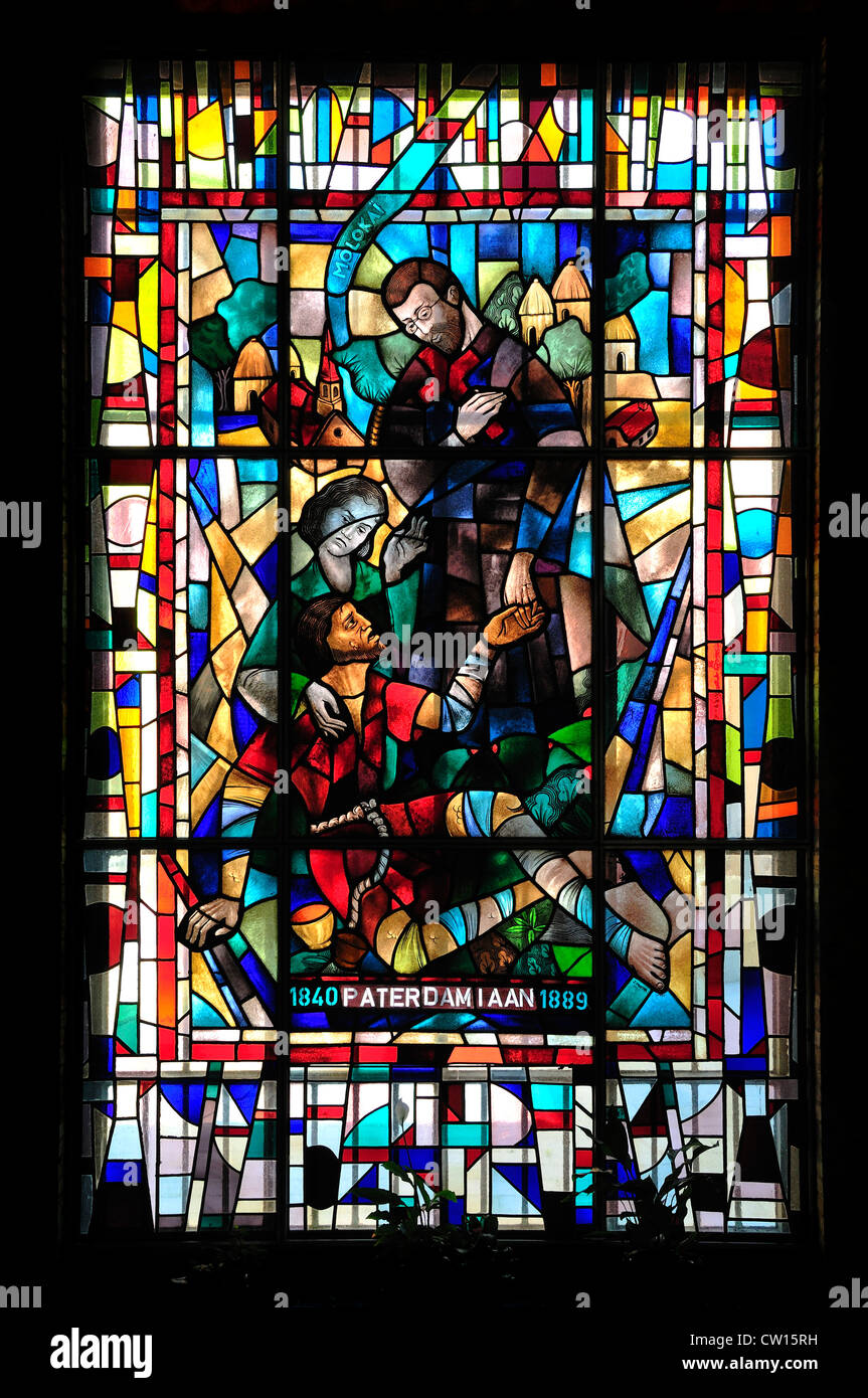 Leuven / Louvain, Belgium. Sint Antonius Kapel - 14thC Stained glass window (J Mortier 1951) 'Father Damien' - Joseph de Veuster Stock Photo