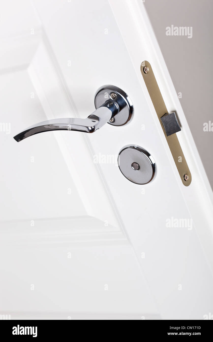 Modern style silver door handle on white door Stock Photo