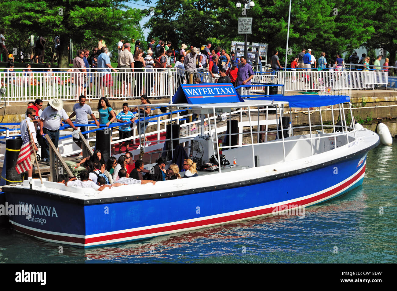 USA Illinois Chicago Tourists board a water taxi that is docked at Navy Pier. Stock Photo
