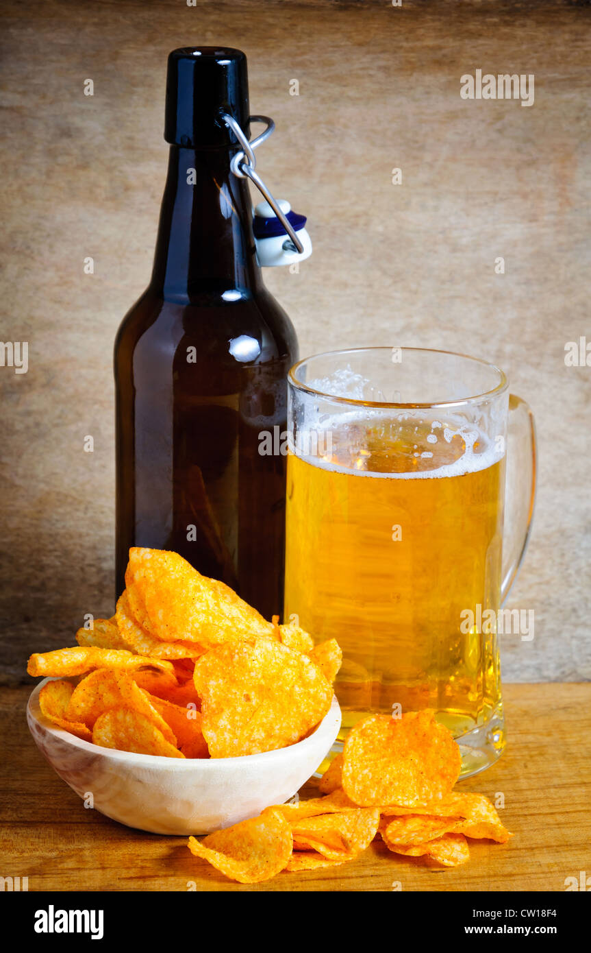 Potato chips, glass and bottle of beer Stock Photo Alamy