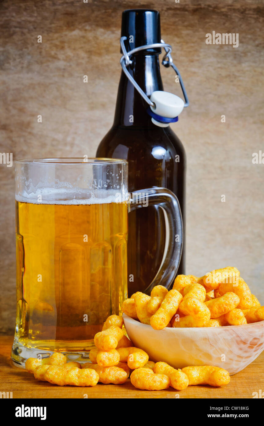 Beer mug and bottle with peanut curls Stock Photo