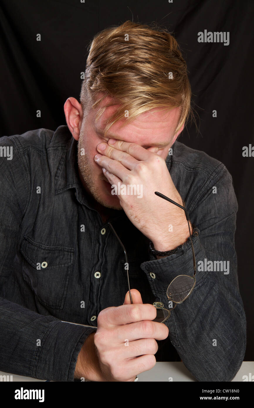 Young man stressed Stock Photo - Alamy