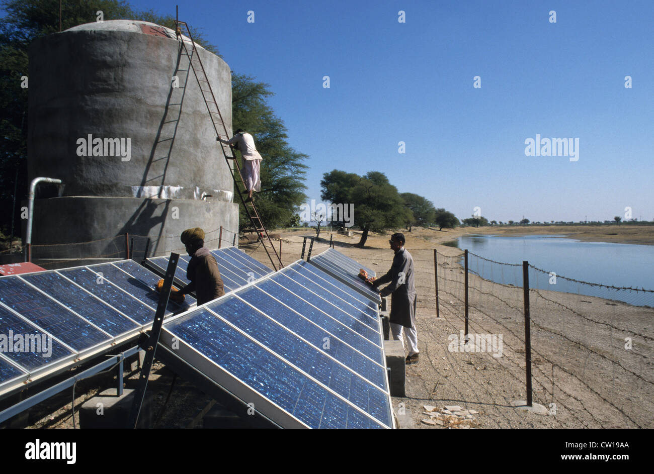INDIA Rajasthan solar powered water pump to store water in a village tank promoted by Tilonia barefoot college Stock Photo