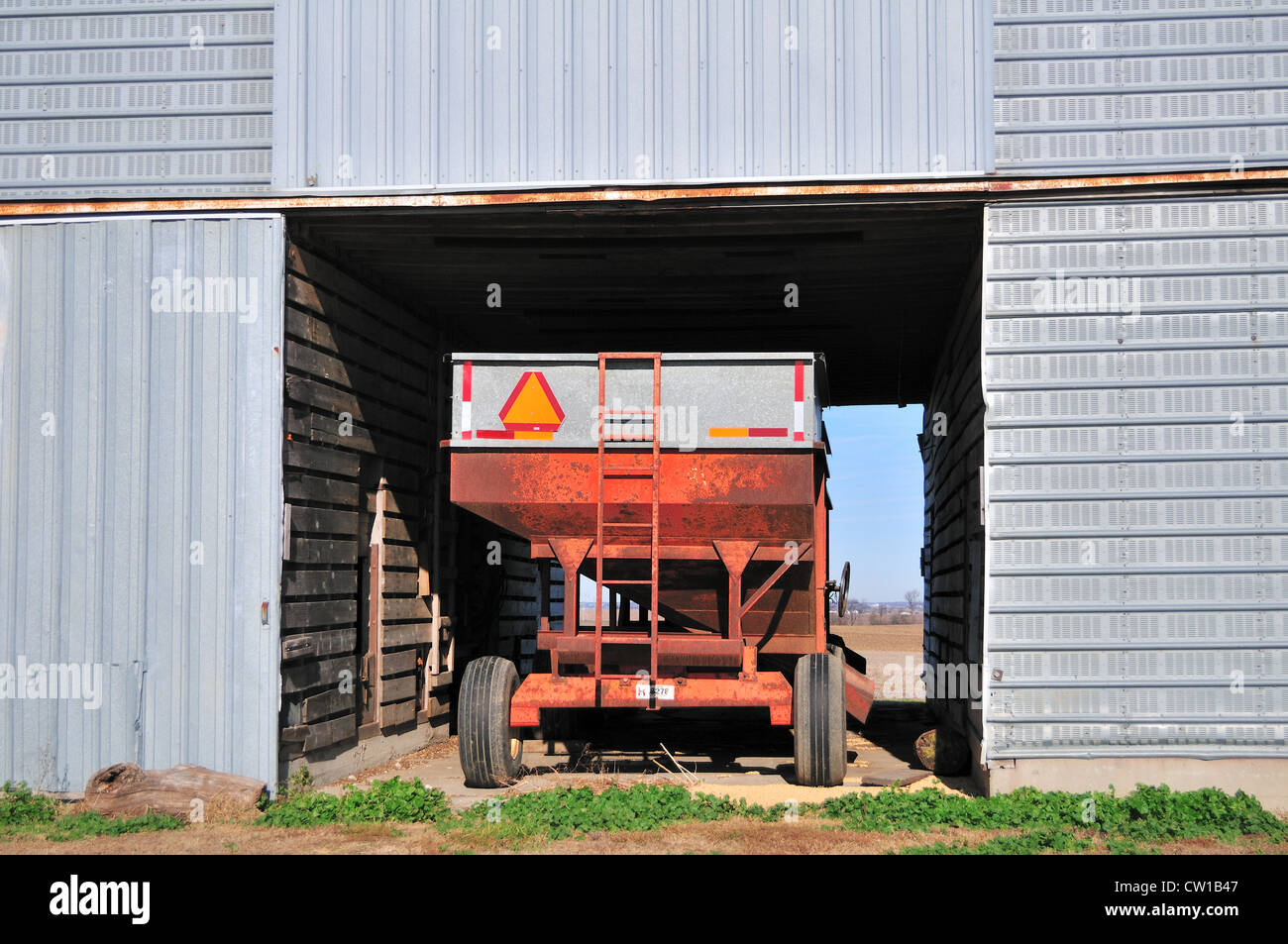 USA Agriculture A crop wagon sits idly in a corrugated steel storage barn in rural northern Illinois. Stock Photo