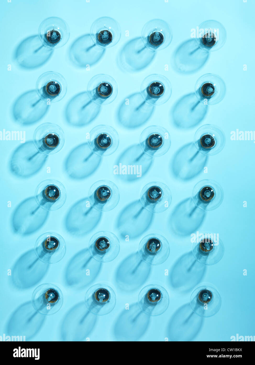Group of turned off incandescent tungsten light bulbs on blue background Stock Photo