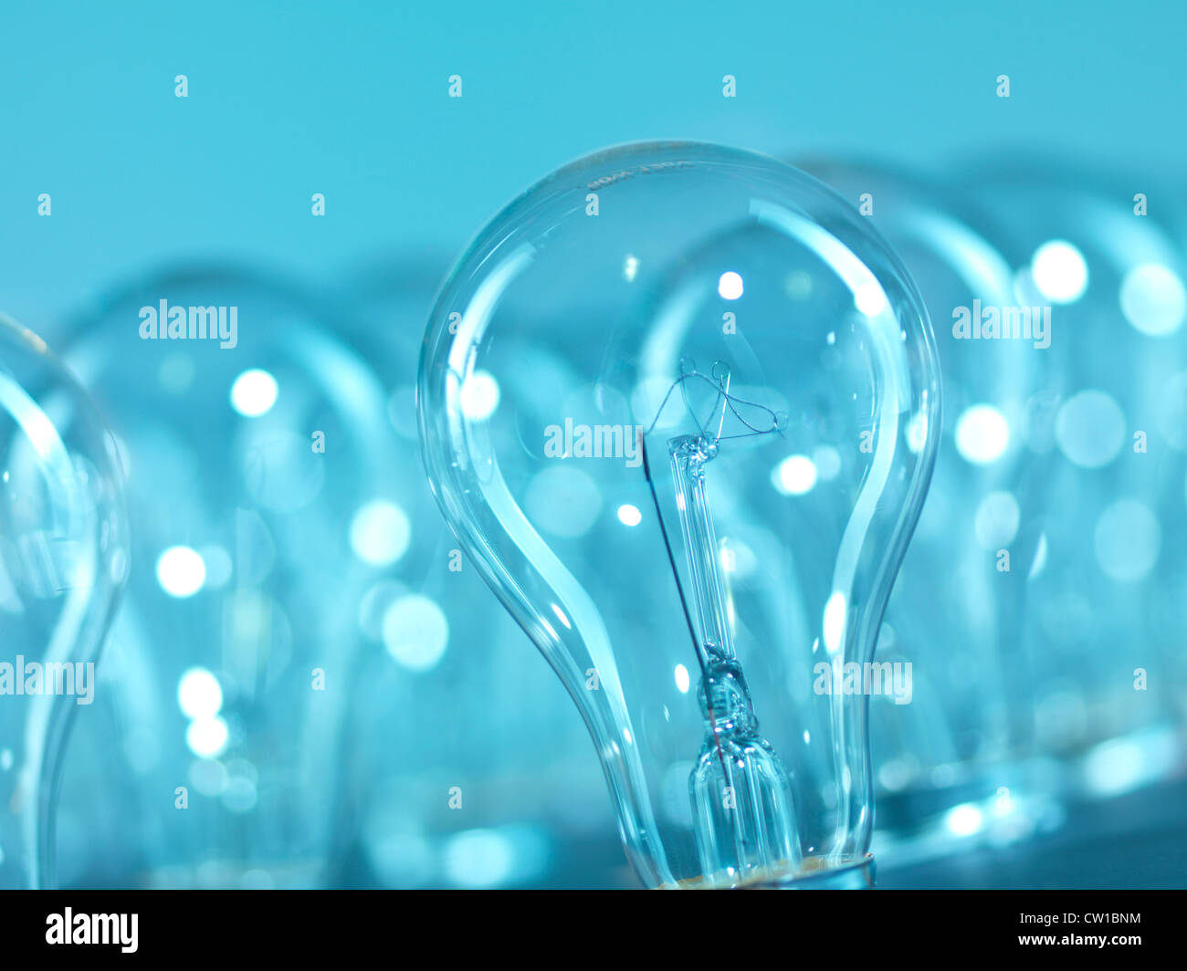 Incandescent tungsten light bulbs abstract blue background Stock Photo