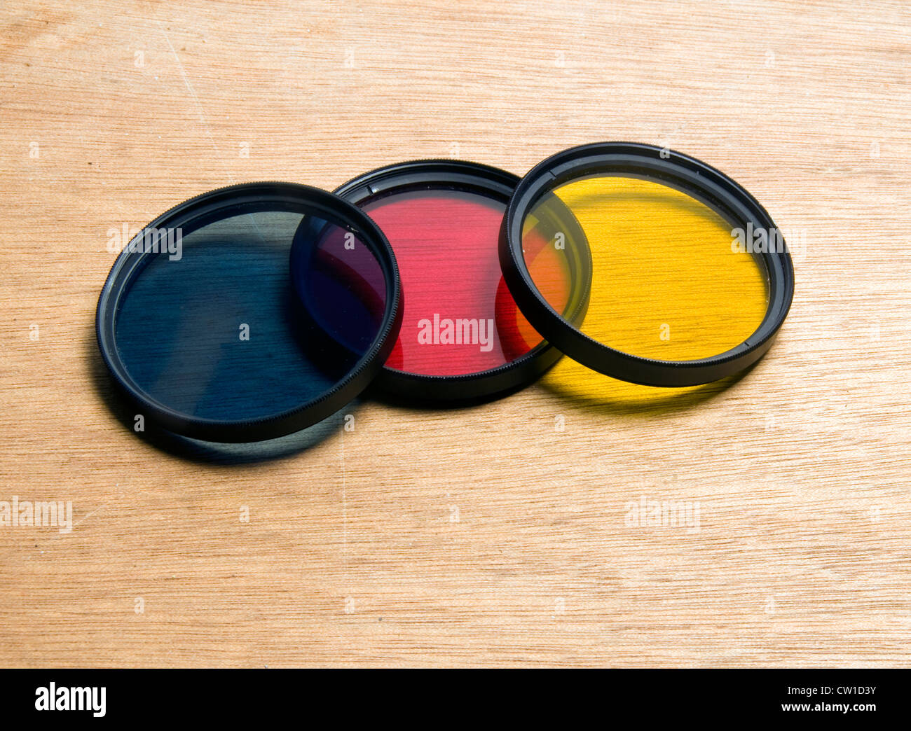 screw in camera lens filters blue red yellow for black & white film Stock Photo