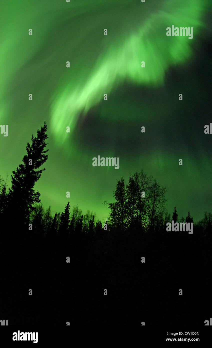 Aurora Borealis or Northern Lights above Bear Lake in Alaska, solar particles colliding with gases in Earth's atmosphere. Stock Photo