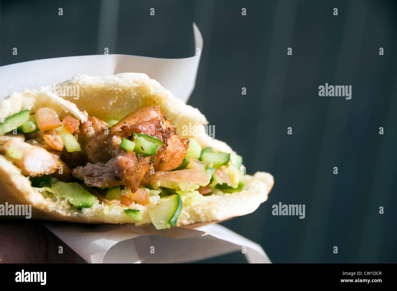 street food pita falafel sandwich with chicken and salad vegetables photographed in Jerusalem Israel Stock Photo