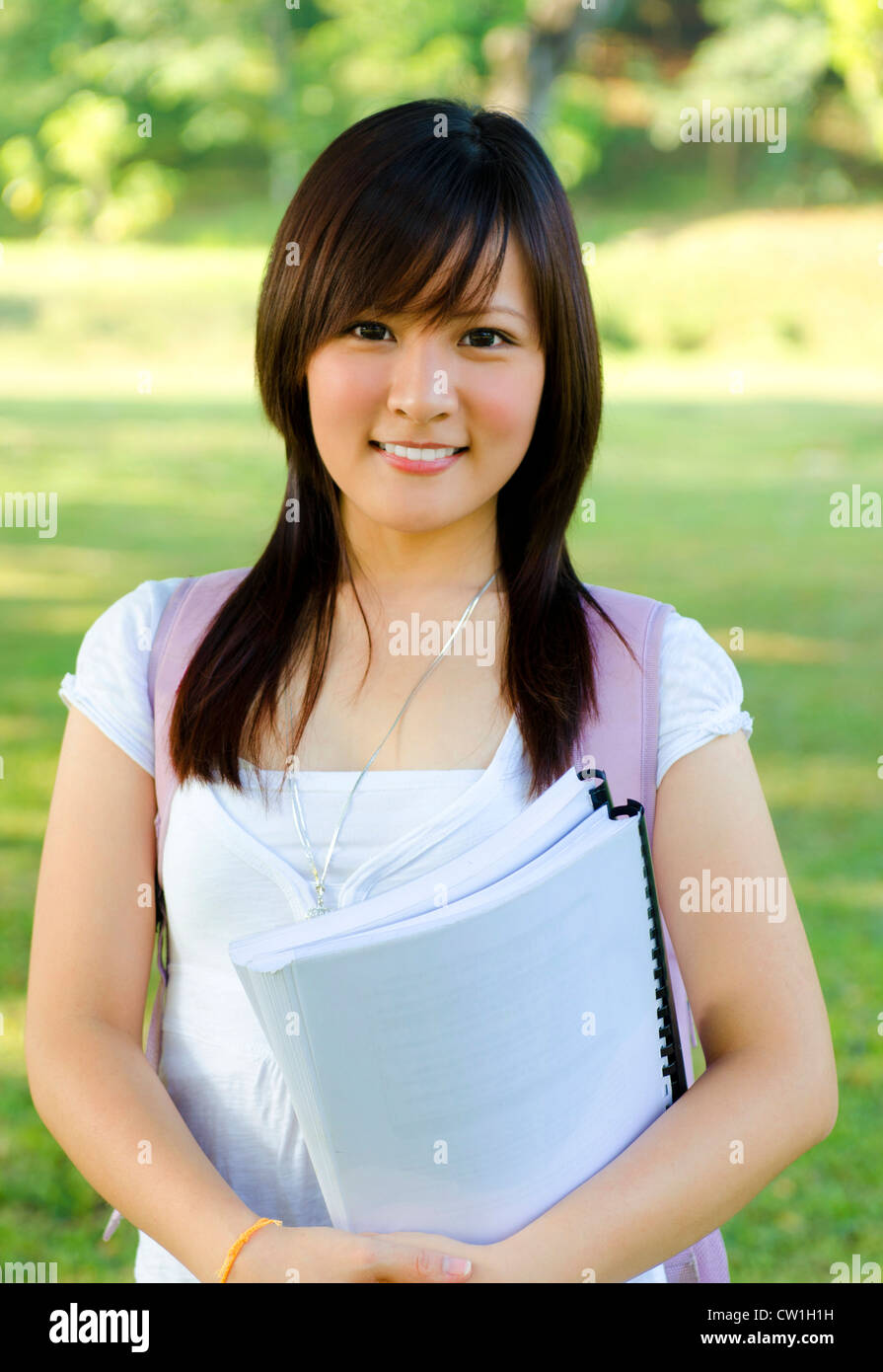 College student standing outside campus, green park Stock Photo - Alamy