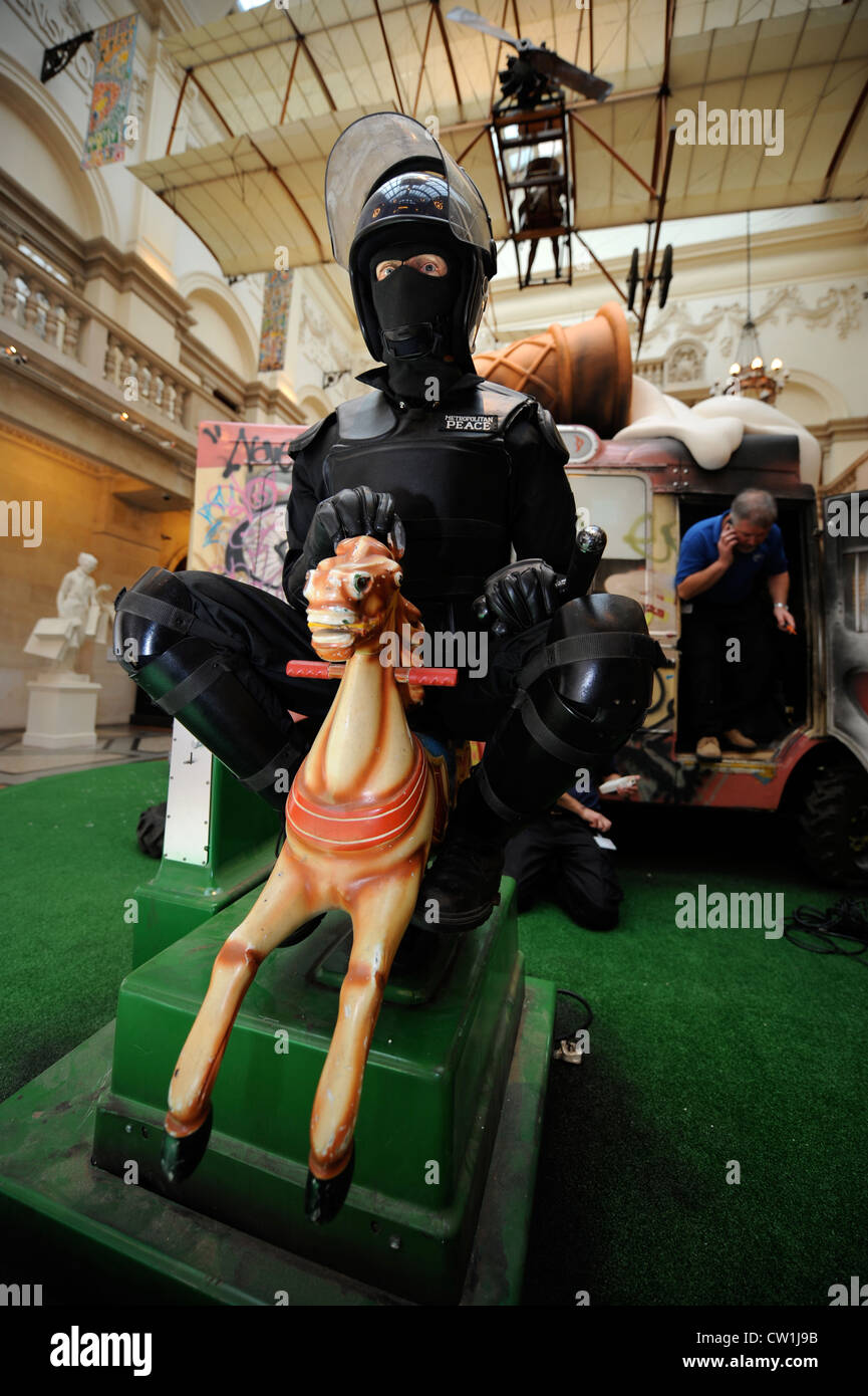 The 'Banksy Versus Bristol Museum' exhibition June 2009 - Riot policeman riding a fairground horse Stock Photo