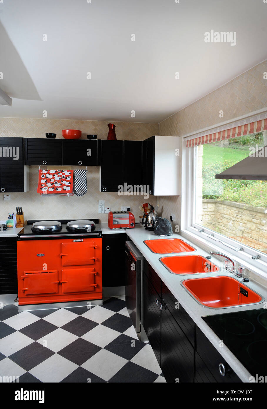 A kitchen with red aga oven in a 1970's style house which was featured in a 1975 magazine makeover UK Stock Photo