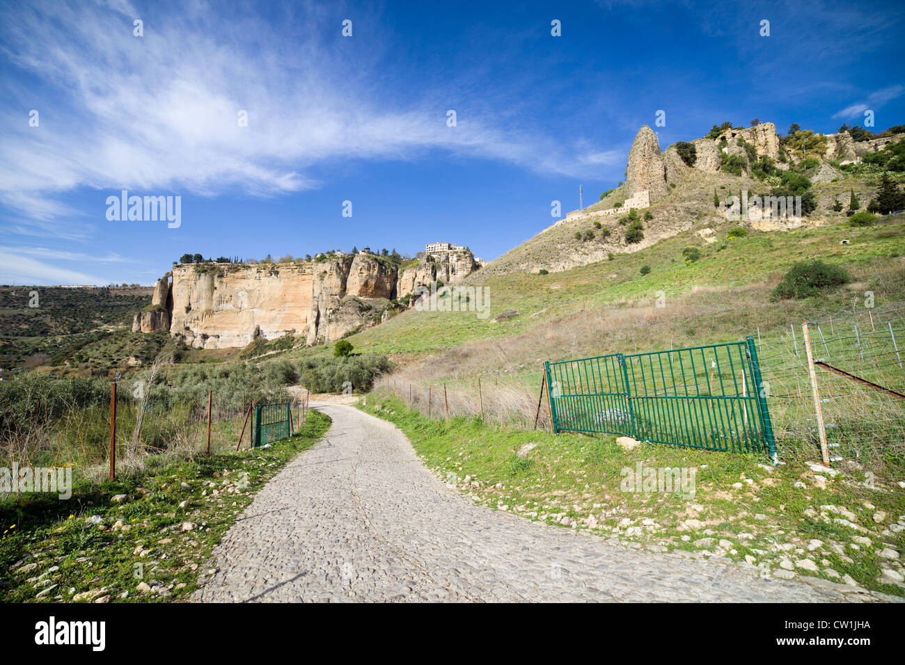 Rural road through a scenic Andalusian hilly landscape in southern Spain, Malaga province. Stock Photo