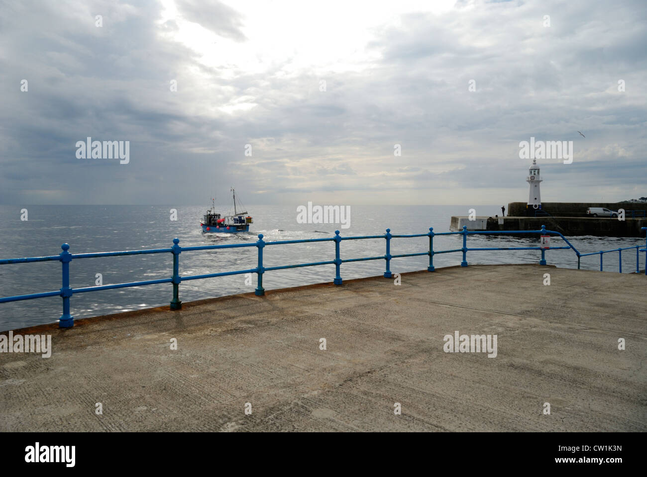 Fishing boat leaving the harbour at Mevagissey, Cornwall, England Stock Photo