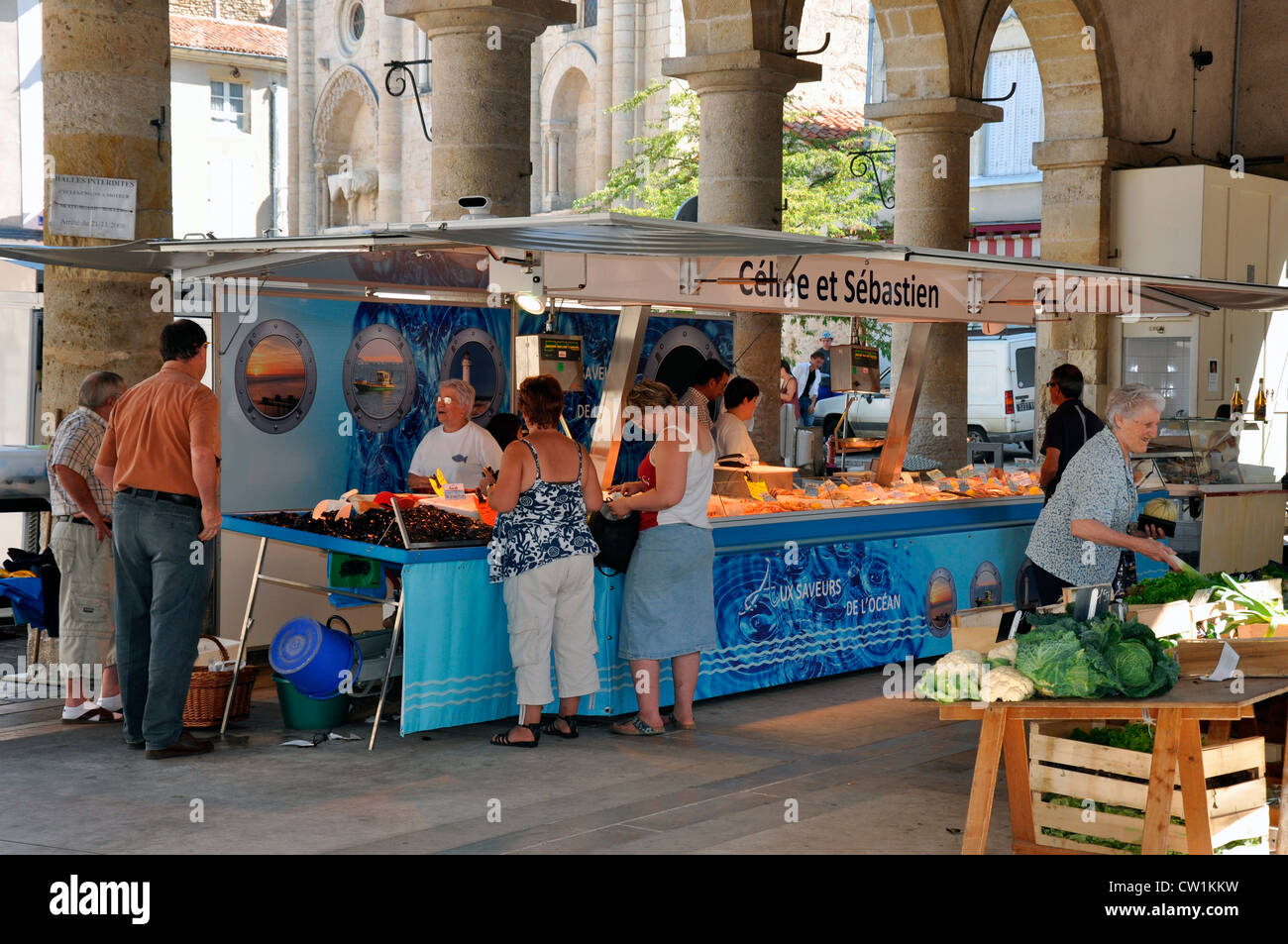 Shoppers at under cover fresh food market in the small medieval French town of Airvault, Deux-Sèvres department, Nouvelle-Aquitaine, France, Europe. Stock Photo