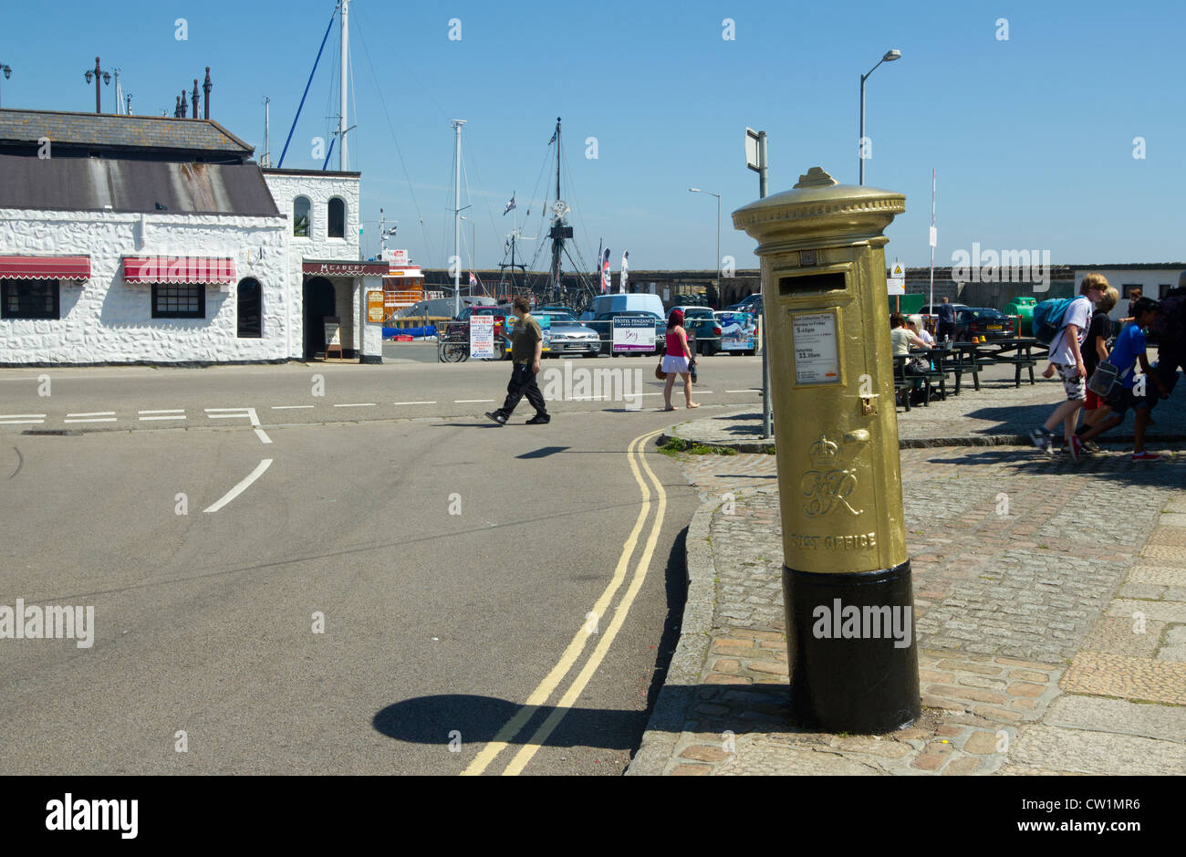 Royal Mail post box painted gold in honour of Helen Glover, 2012 London Olympics gold medal winner.  Penzance UK. Stock Photo