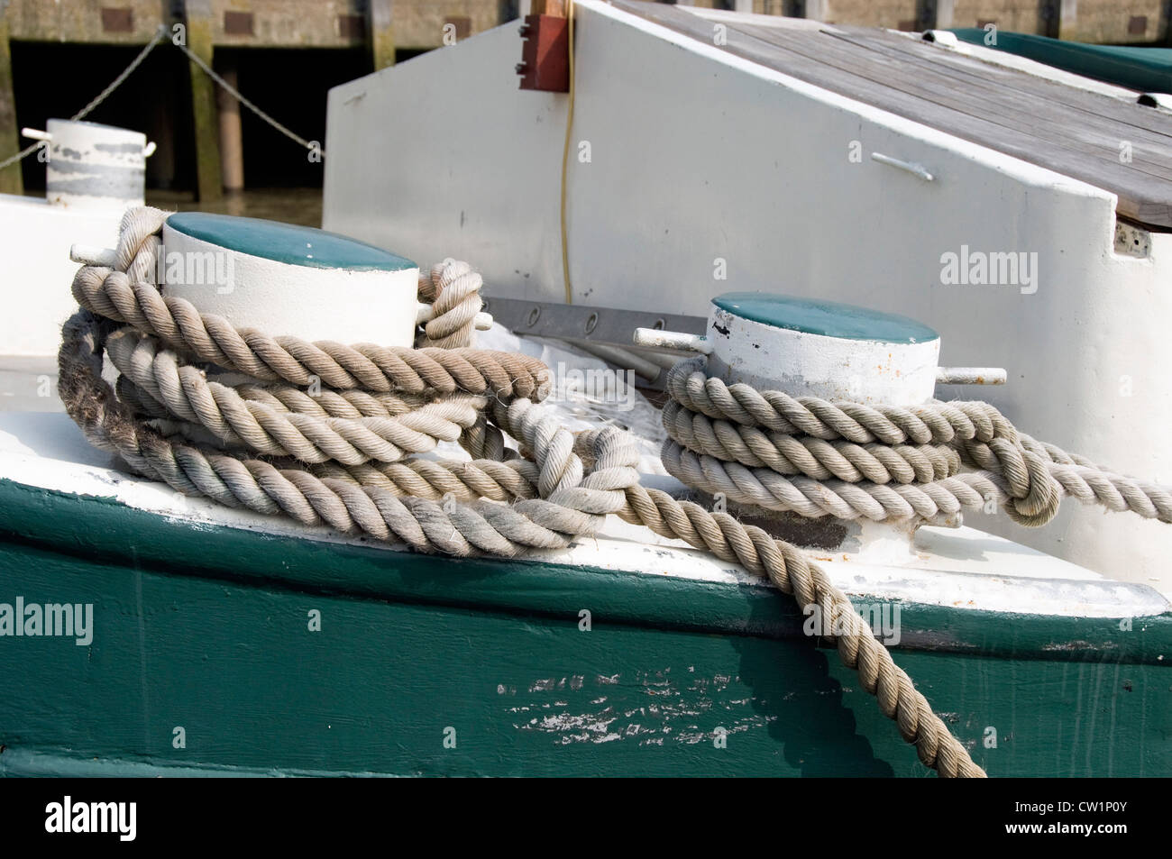 Rope tied round mooring bollards on board boat Stock Photo Alamy