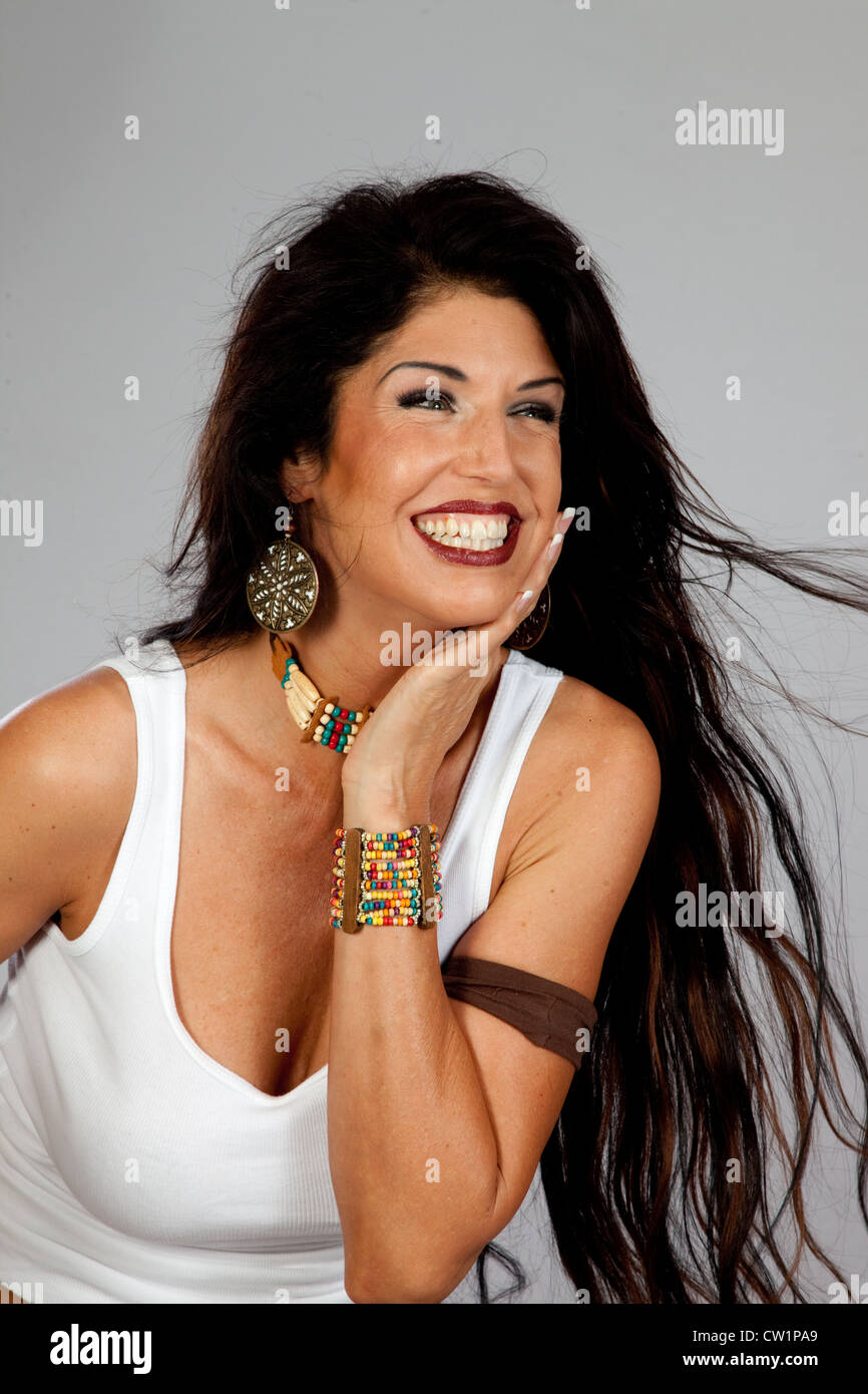 Pretty Mature Woman With Long Black Hair And American Indian Choker Laughing With Joy Stock