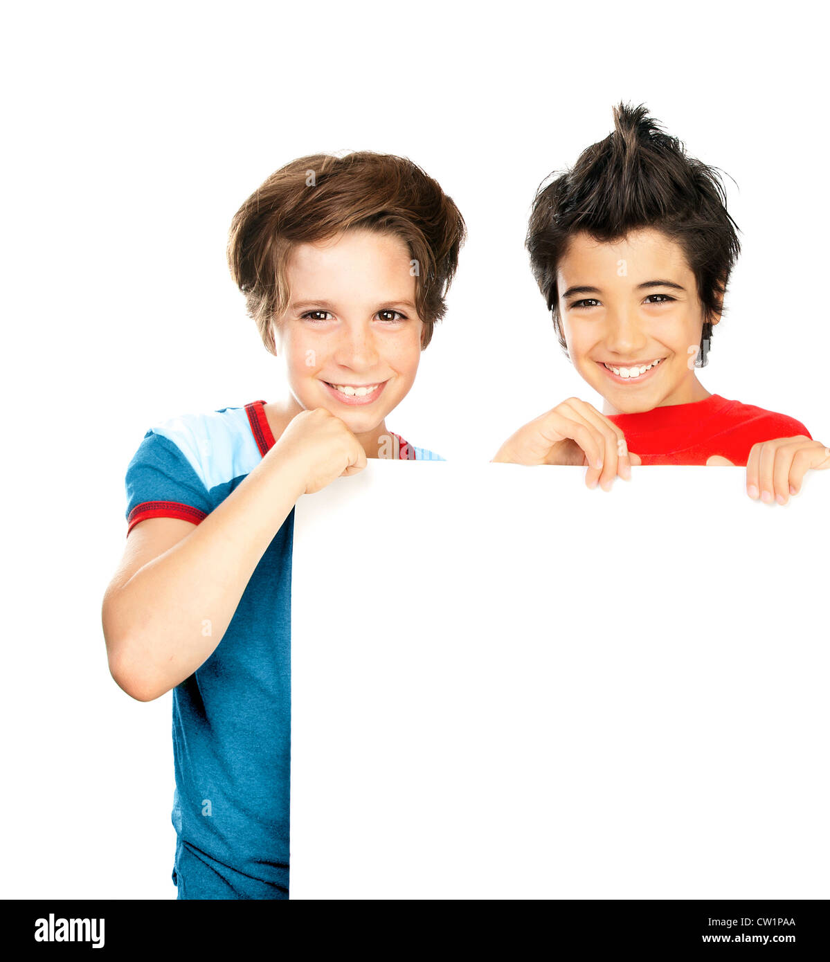 Two happy boys isolated on white background, cute male classmates hold white blank class board, group of teenager playing Stock Photo
