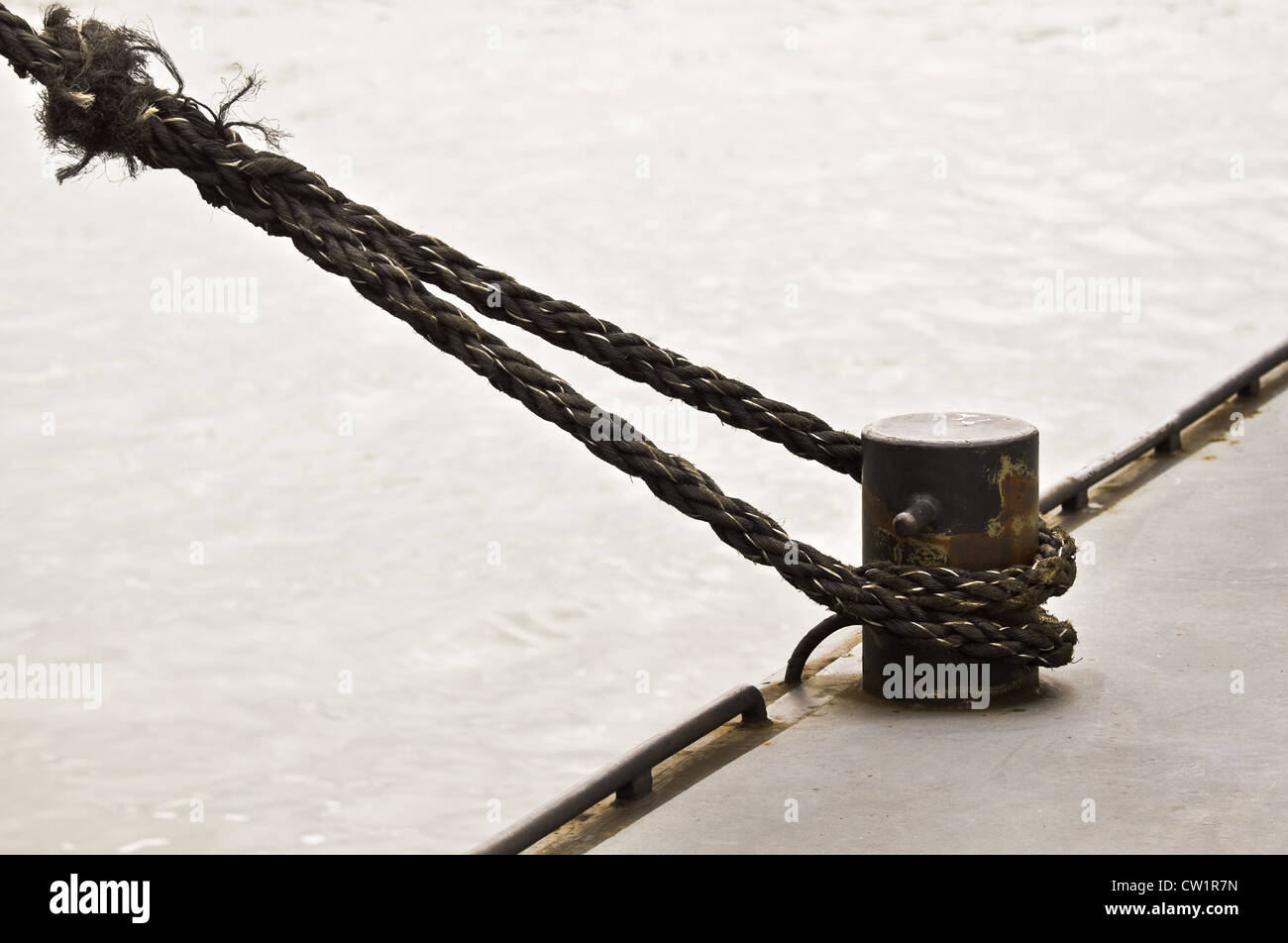 Ship rope and mooring-mast with desaturated colors Stock Photo
