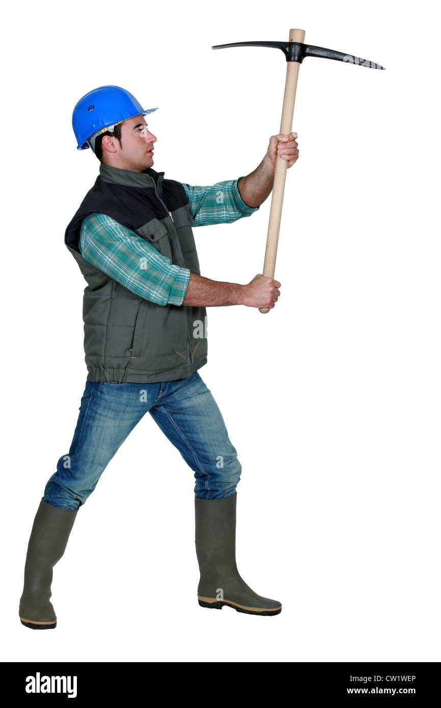 picture of craftsman holding pickaxe in profile Stock Photo