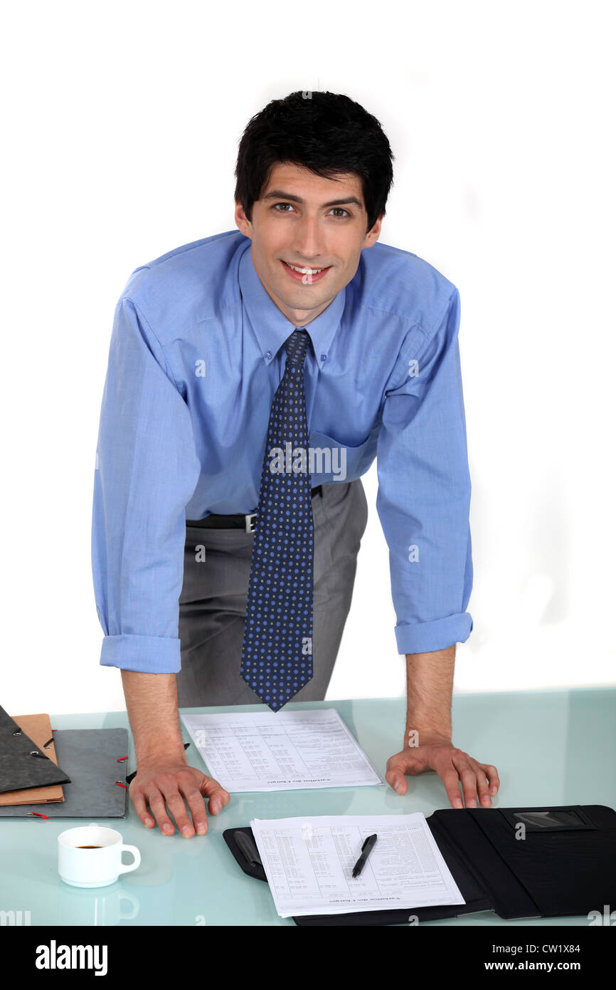 Worker stood by desk Stock Photo