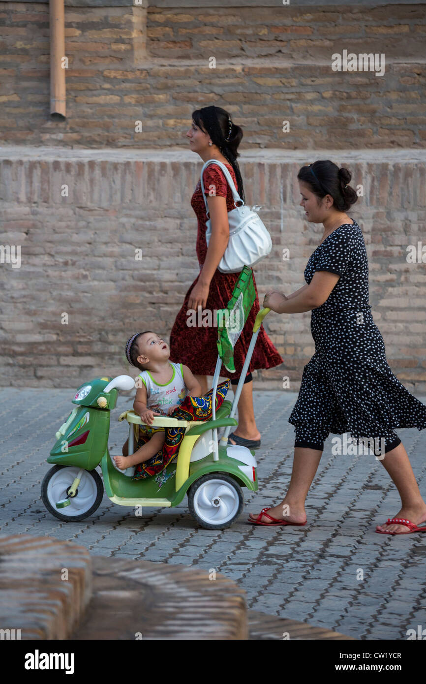 Uzbek woman with child in baby buggy, Khiva, Uzbekistan Stock Photo - Alamy