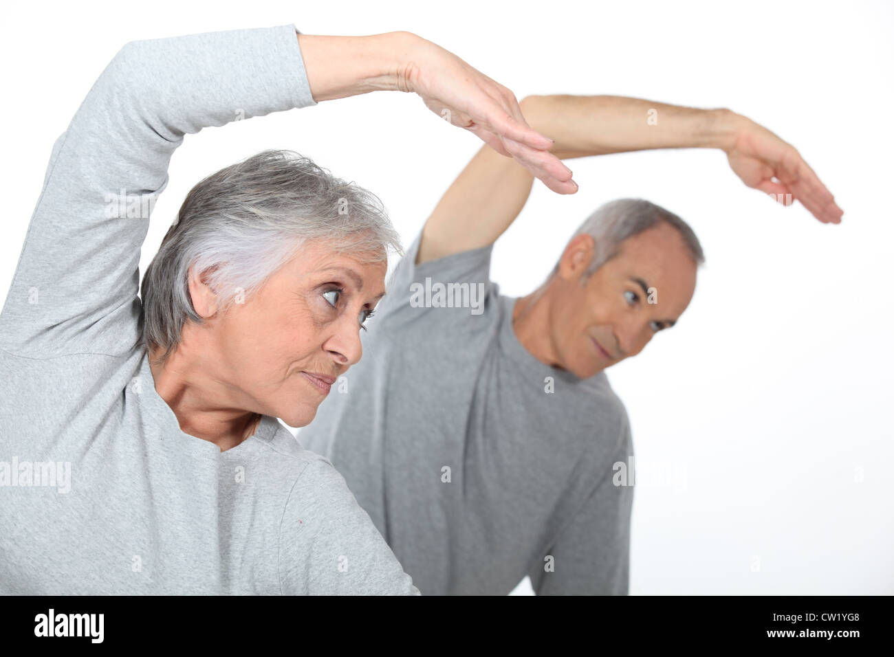 Senior couple stretching in the gym Stock Photo - Alamy