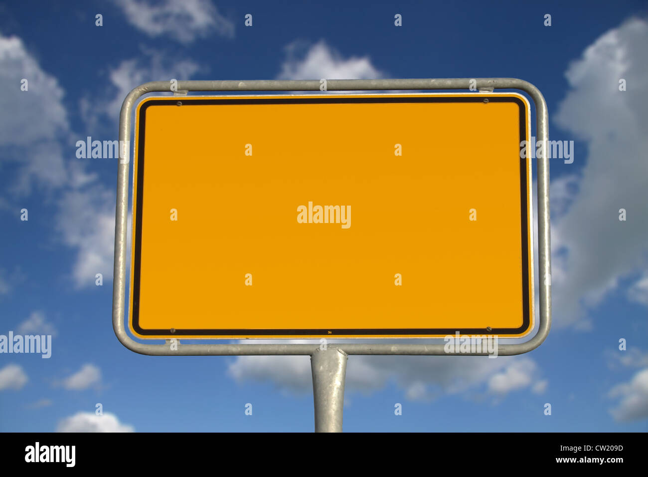 German road sign with blue sky and white clouds Stock Photo