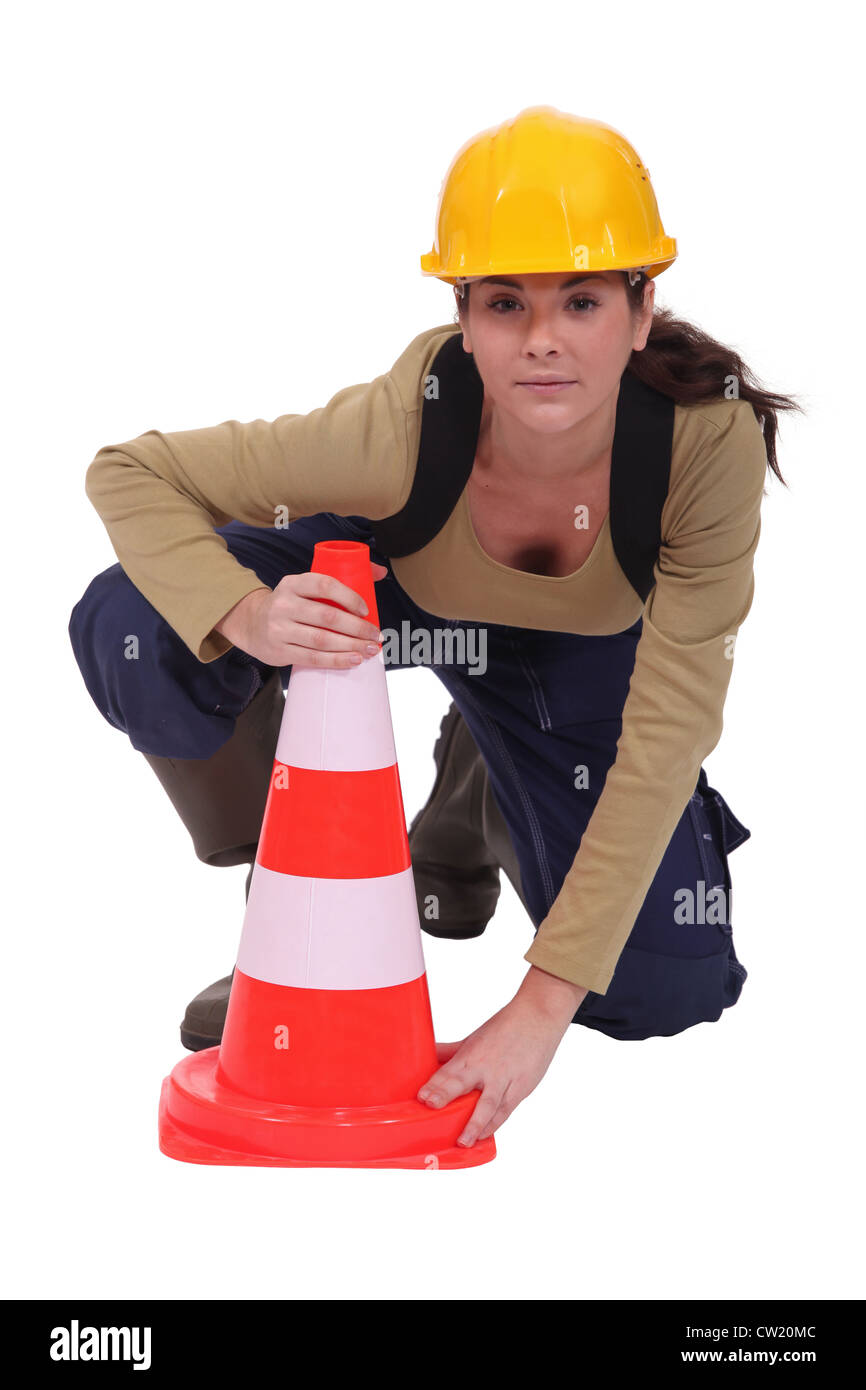 Labourer placing a traffic pylon Stock Photo Alamy