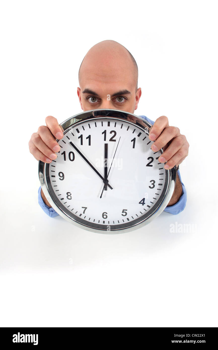 man holding a huge clock Stock Photo - Alamy