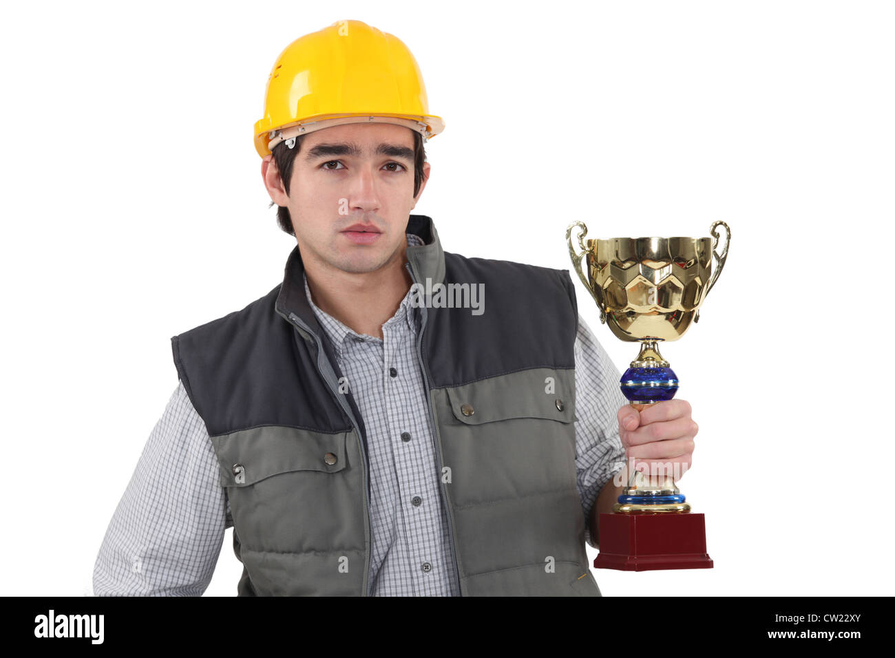 Laborer holding gold cup Stock Photo - Alamy