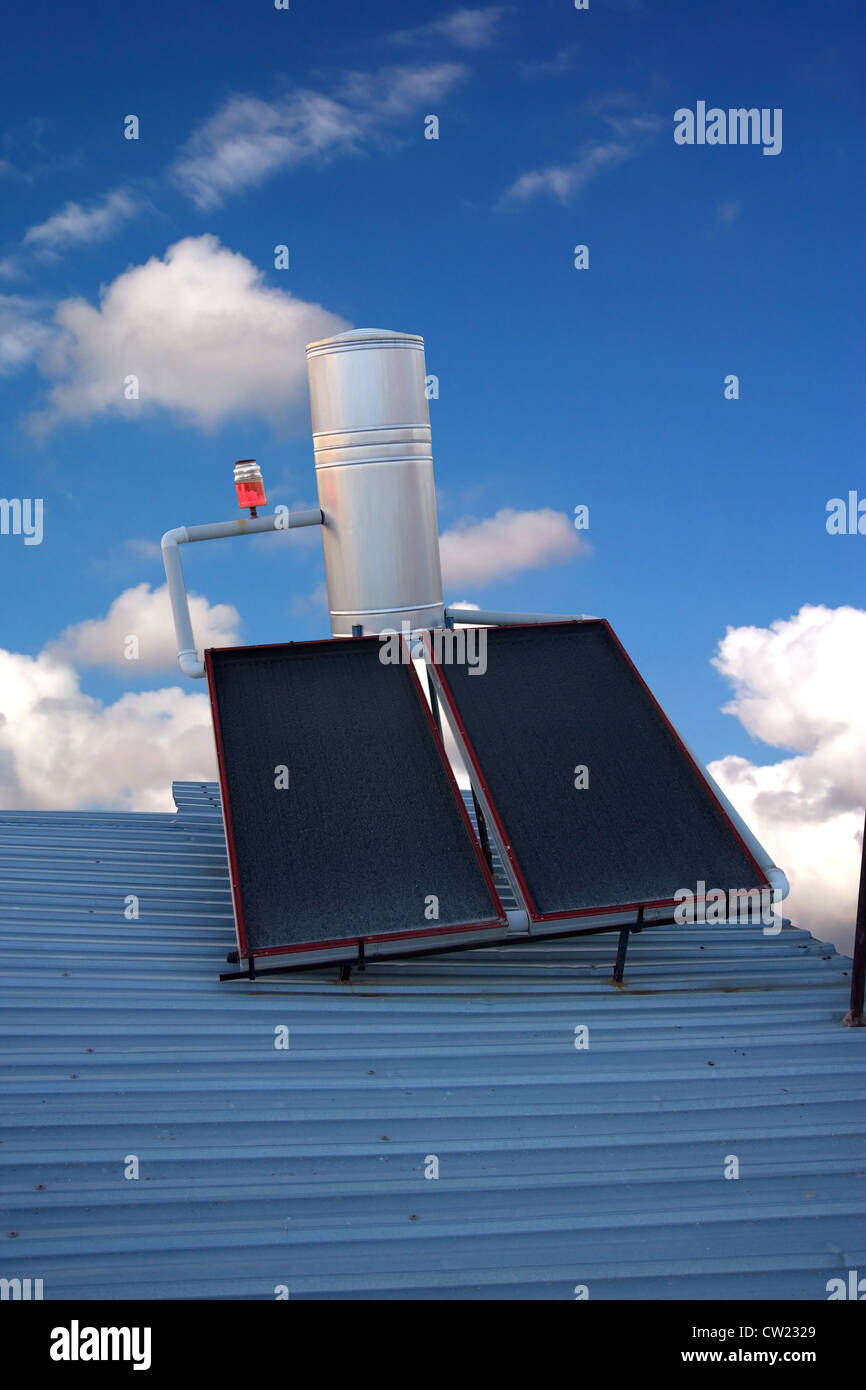Solar water heating panels on a house roof Including clipping path Stock Photo
