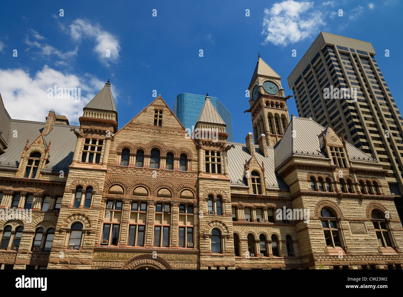 Refurbished stonework of the old 1889 Toronto City Hall with highrise buildings downtown Toronto Stock Photo