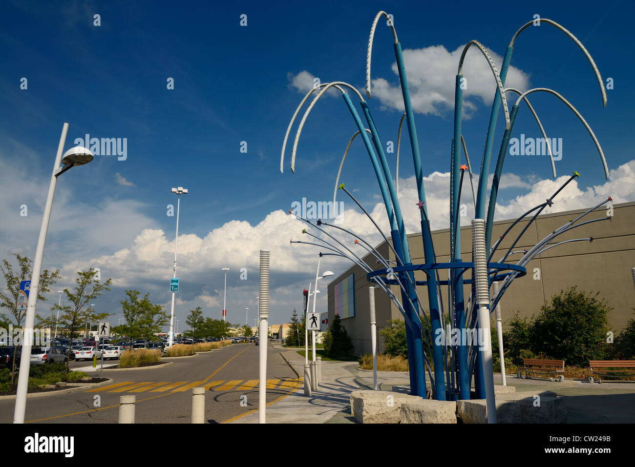 Empty road at a suburban mall entrance with blue sky and clouds Stock Photo