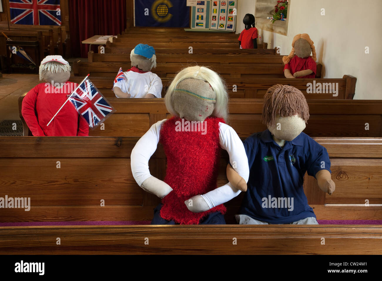 St Mary's Church, Kettlewell. Stuffed straw dolls sat in pews at Kettlewell annual Scarecrow festival, Upper Wharfdale,  North Yorkshire Dales, UK Stock Photo