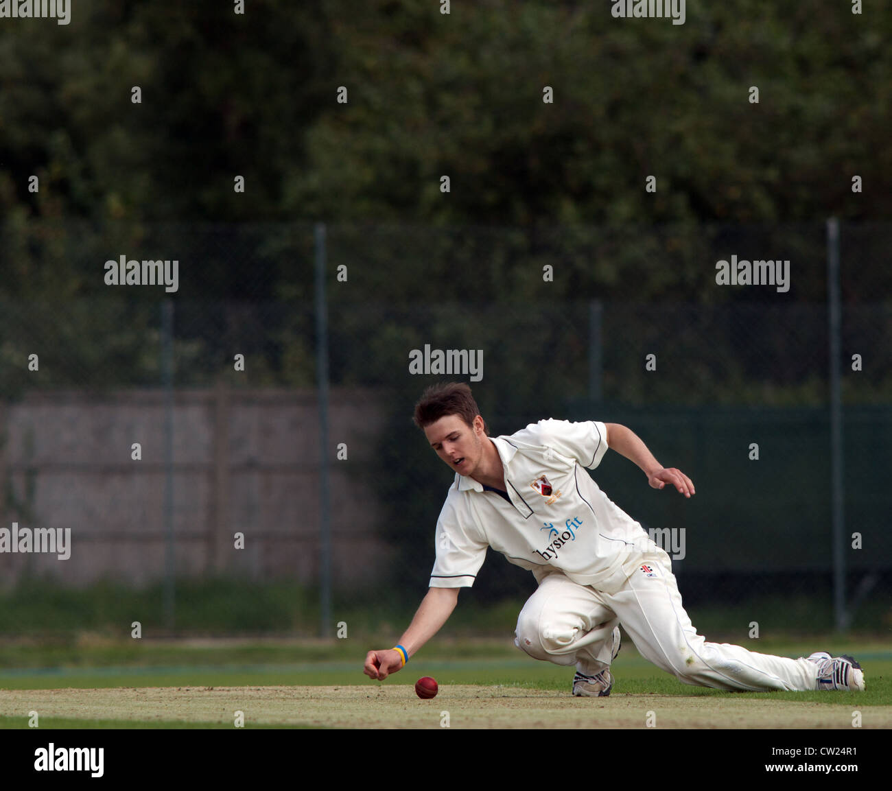 a bowler fields off his own bowling in a match between alderley edge and hyde in the cheshire