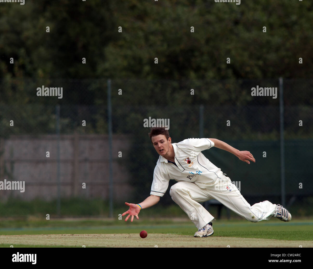 a bowler fields off his own bowling in a match between alderley edge and hyde in the cheshire