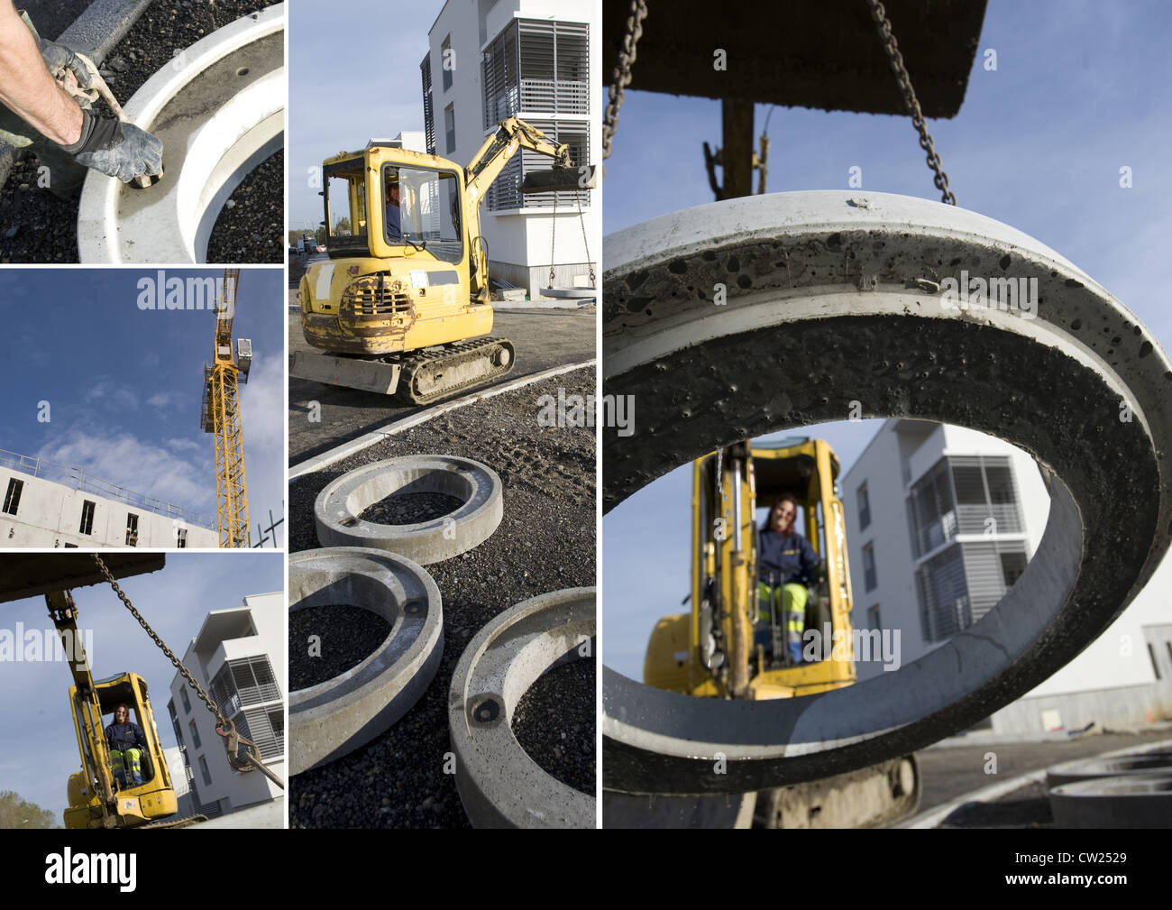 Construction vehicle lifting concrete ring Stock Photo