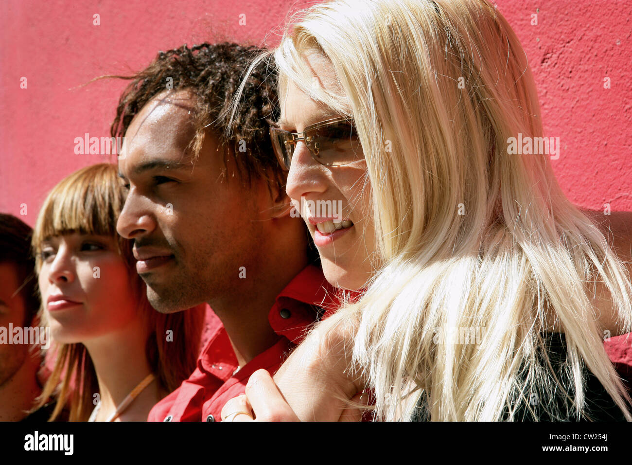 Young people against a wall Stock Photo - Alamy
