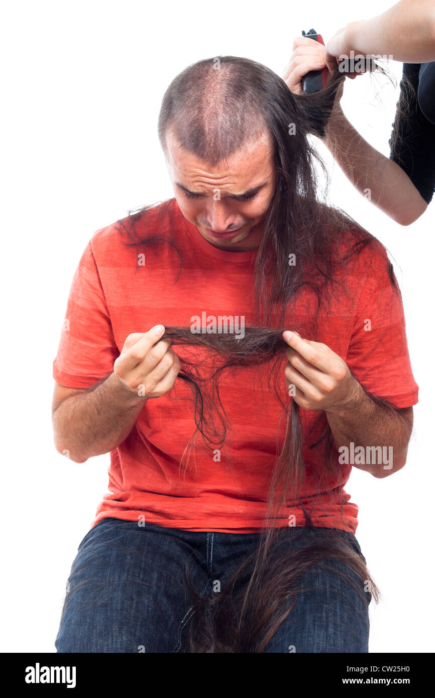 Unhappy Bald Man Holding His Long Hair And Crying Being Shaved